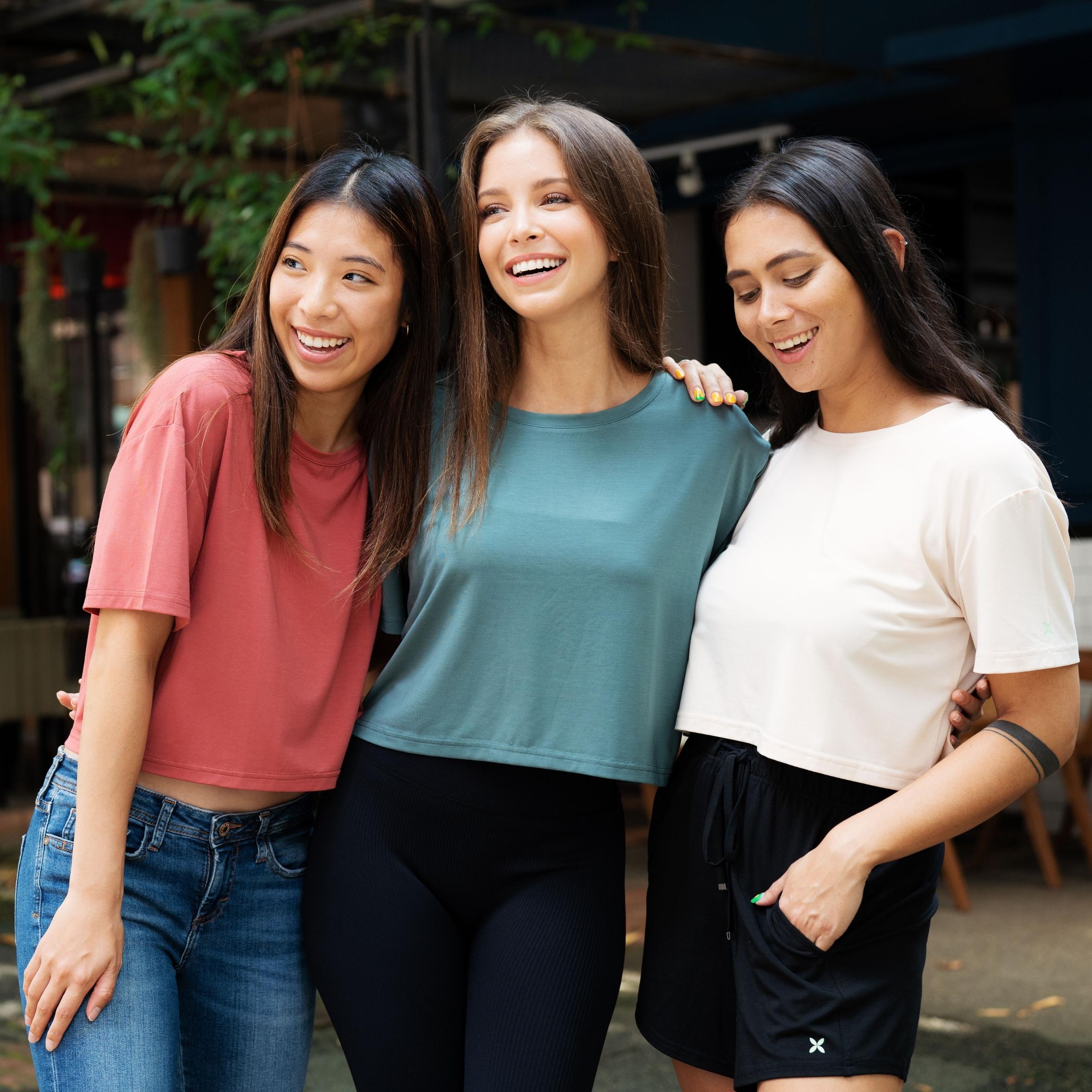 Three women outdoors in Kualesa Relaxed Cropped Tee Tanah Merah, Daun and Pasir